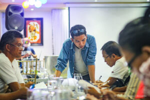 tambuyog development center community organizer for lagonoy gulf jeric dillera works with tuna fishermen as they jot down their daily expenses and earnings and project their savings over the coming months