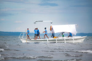 a boat sets sail off the coasts of lagonoy gulf