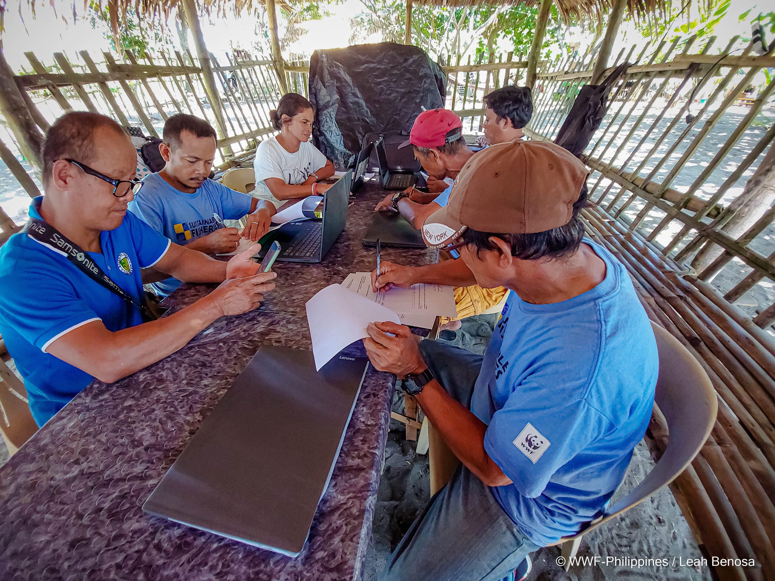 Fishers encode their fish catch data on the shores of the Lagonoy Gulf.