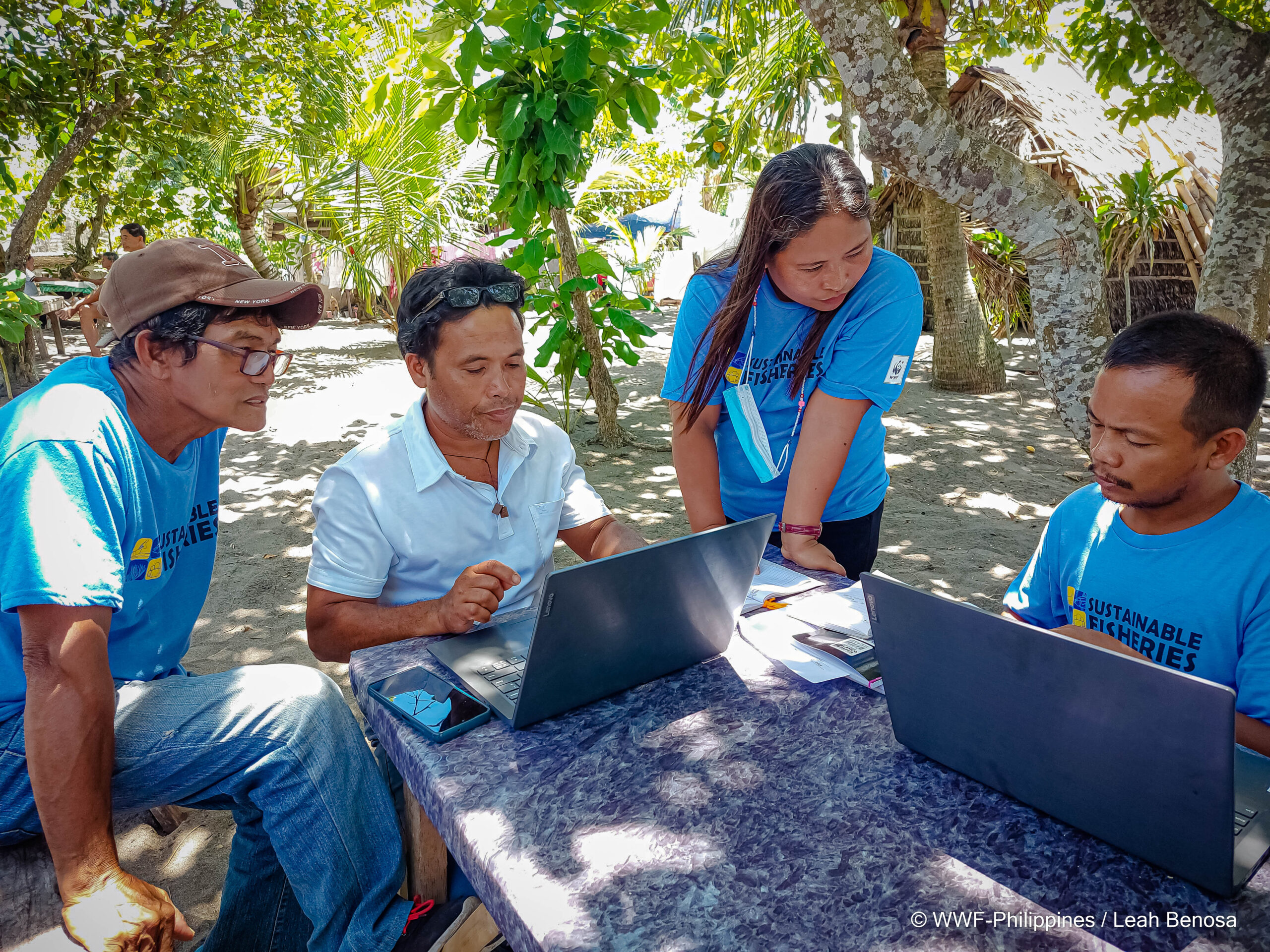 STP 2 Field Officer Manette Coralde guides partner fishers as they digitize their fish catch data.